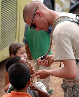 Soldier takes break from construction to interact with Honduran children