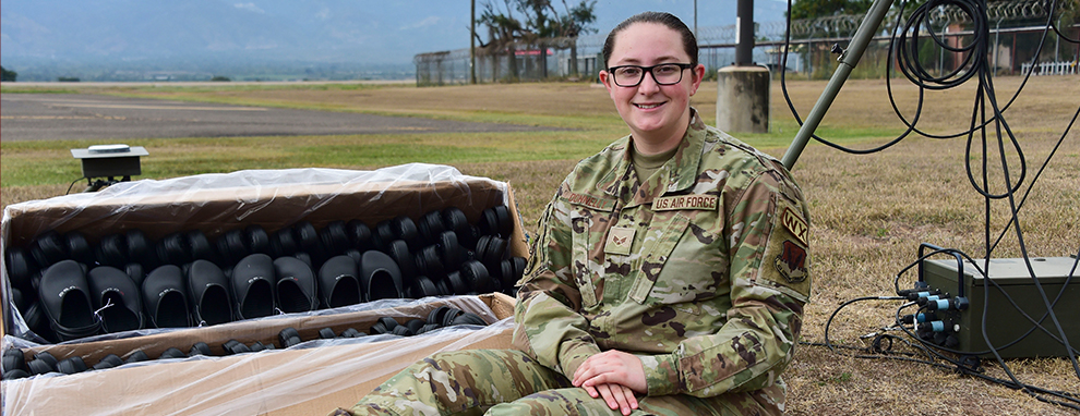 U.S. Air Force volunteer gives shoes to children in Honduras